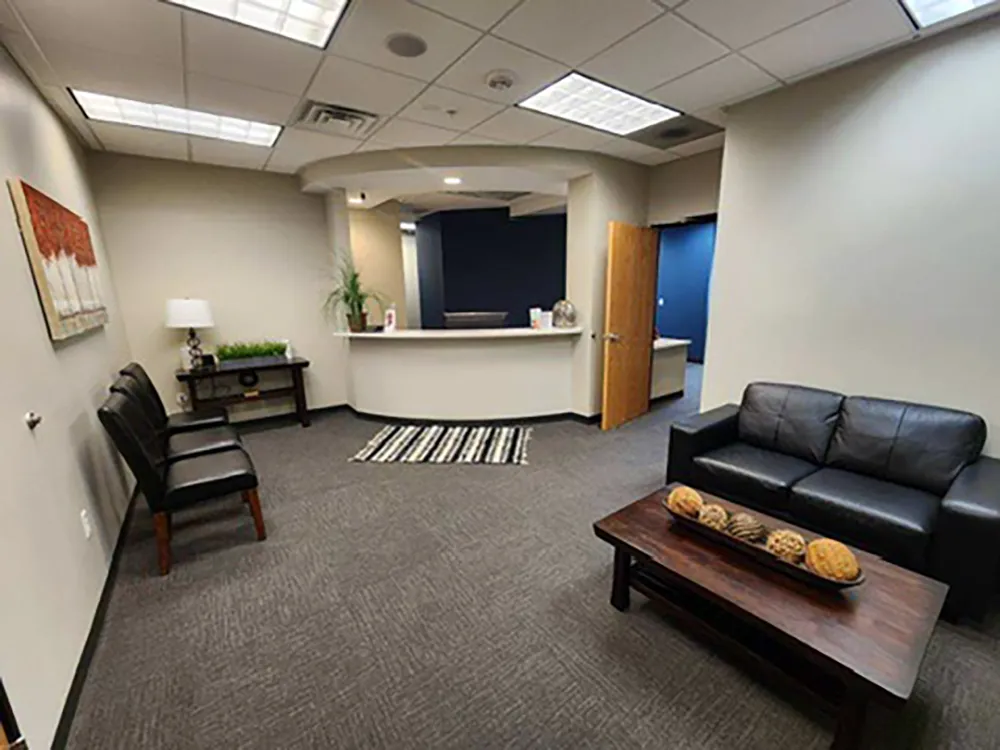 CJ Dental office waiting area with sofas and chairs.