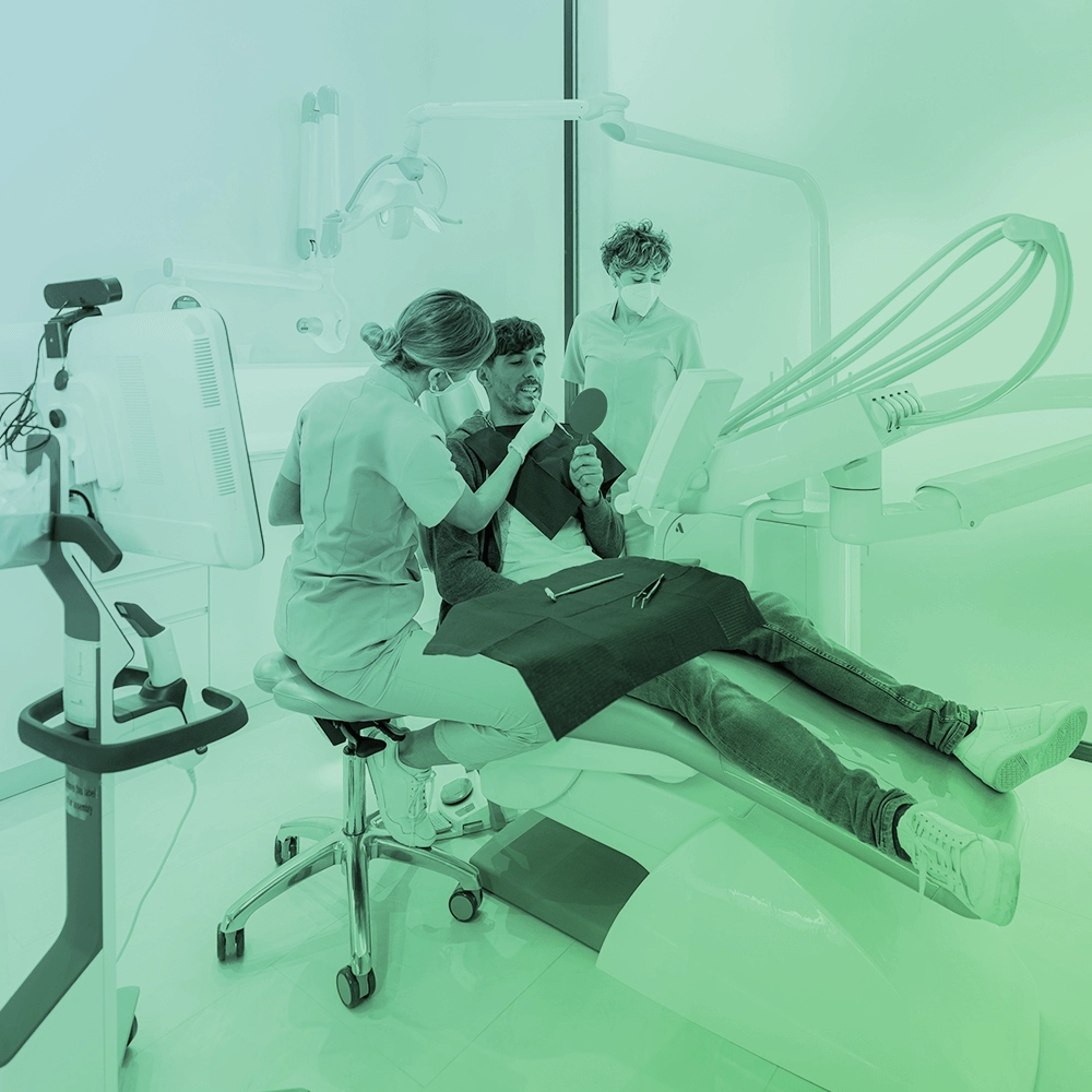 Dentist showing patient something on his teeth.