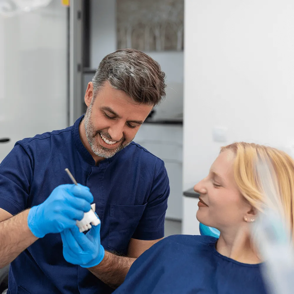 Dentist showing how implants work.