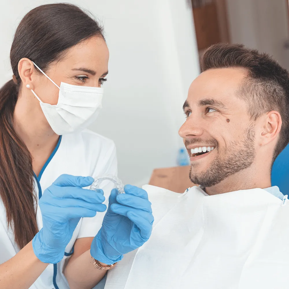 Dentist showing invisalign to a patient.